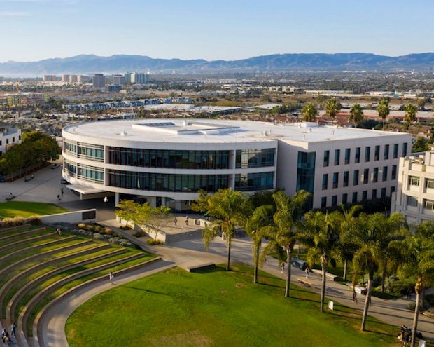 Image of the Noema School of Management building with trees on the side and a lawn in front.