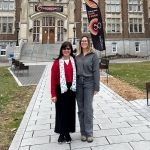 A Vietnamese professor and a Concordia professor smile together in front of Concordia's Loyola campus