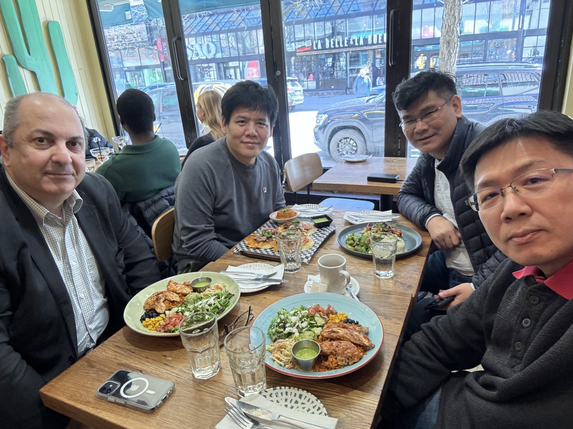 4 delegation members sitting at a table having lunch