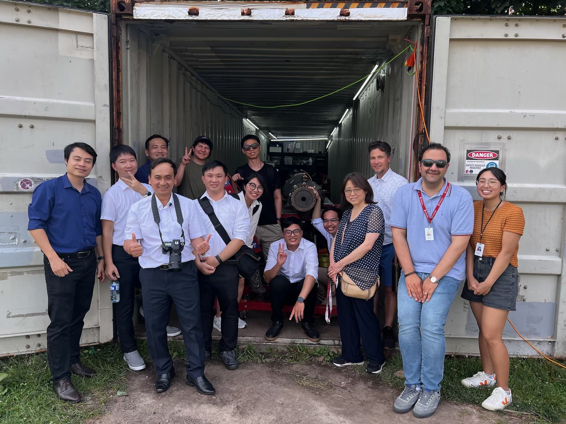 A group of people in front of a container