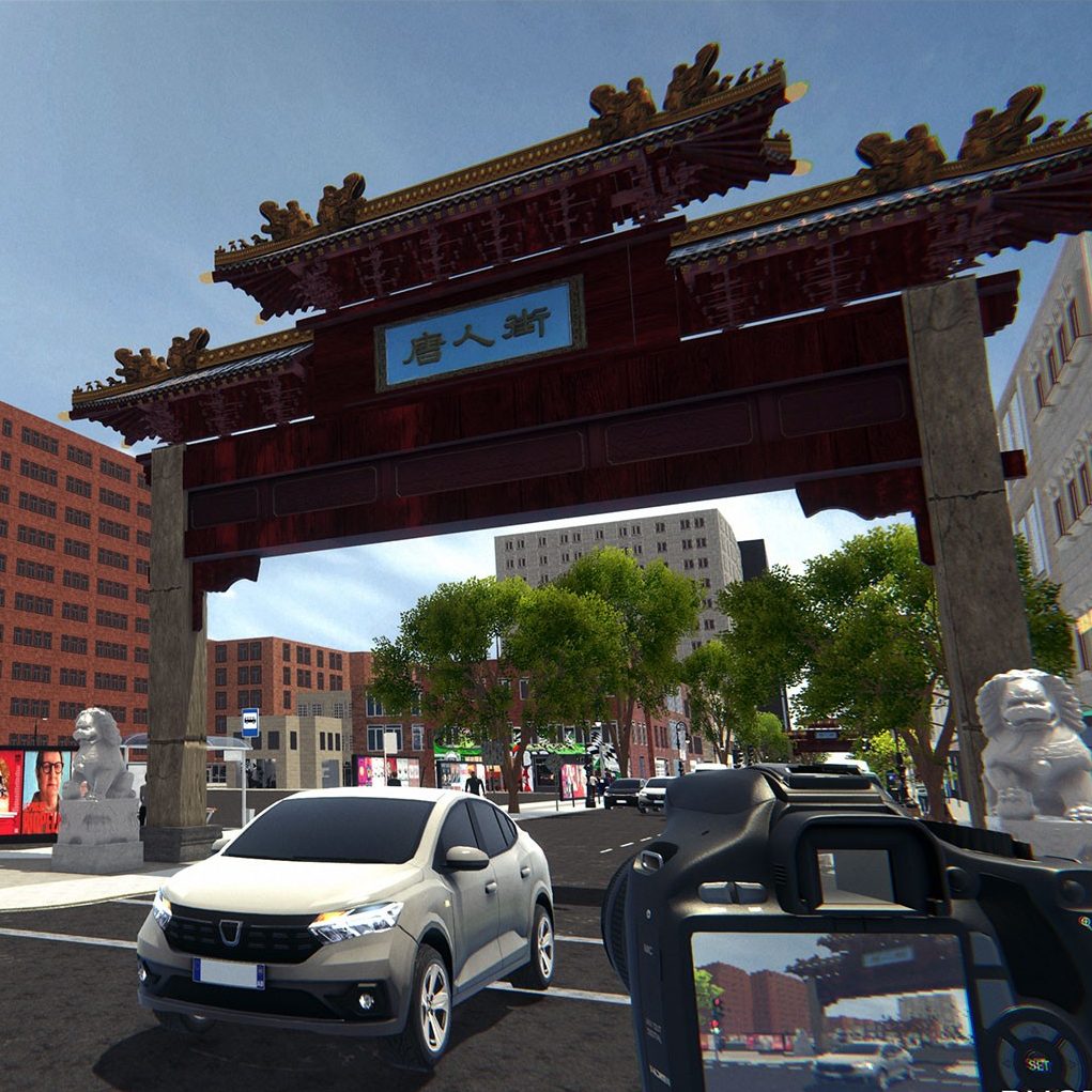 Screenshot of a computer game simulation showing a bustling city street view. A traditional Chinese paifang gate with intricate designs and Chinese characters dominates the foreground. In the background, modern city buildings line the street, while various vehicles, including a prominent silver car, navigate the road.