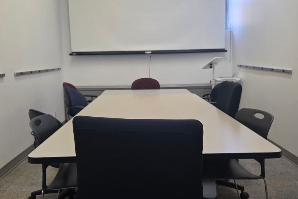 The PY-09-02 meeting room includes a large meeting table seating 10 people and a projector in front of the room