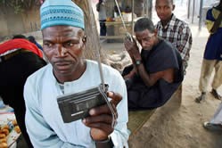 Nigerians listen to the elections on the radio.  IRIN