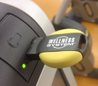 A Technogym Wellness System smart key inserted into an exercise machine