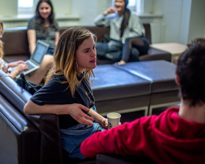 Students conversing in student lounge