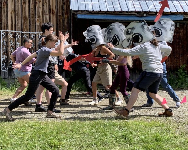 A group of students putting a theater performance outdoors.