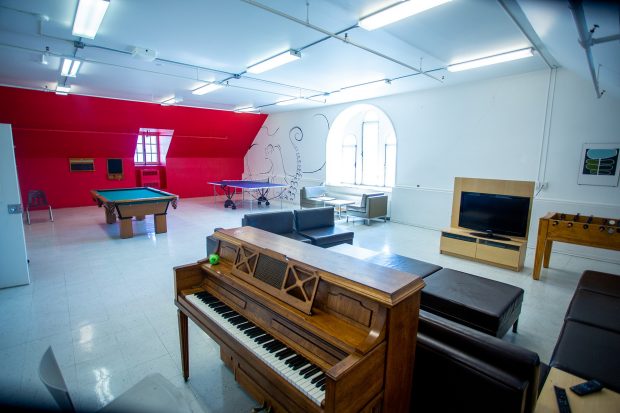 A piano, pool table and ping pong table among other games in the fourth floor games room of the Grey Nuns residence.