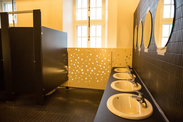 A view of the sinks and stalls in the Grey Nuns residence communal bathroom.
