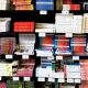 short stacks of books on shelves for purchase at the bookstore