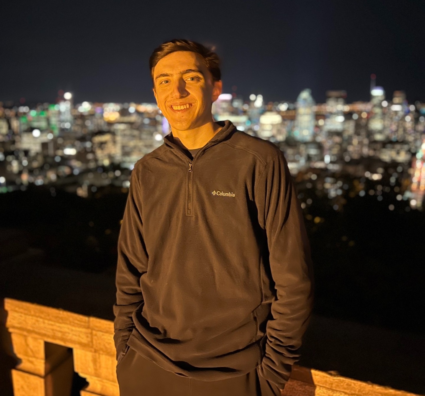 A smiling student mentor standing on top of Mont Royal lookout