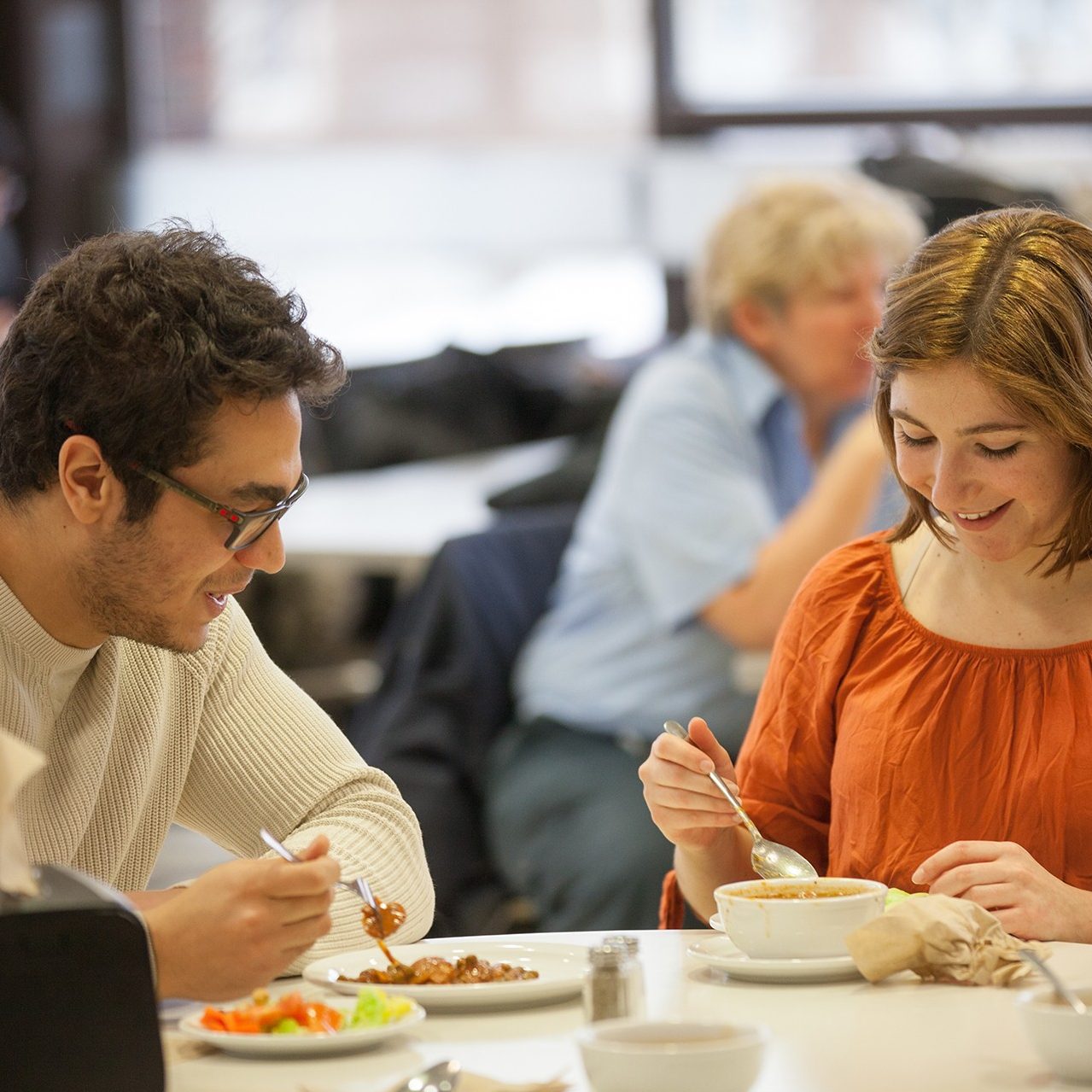 two students eating at Buzz Cafe on Loyola Campus