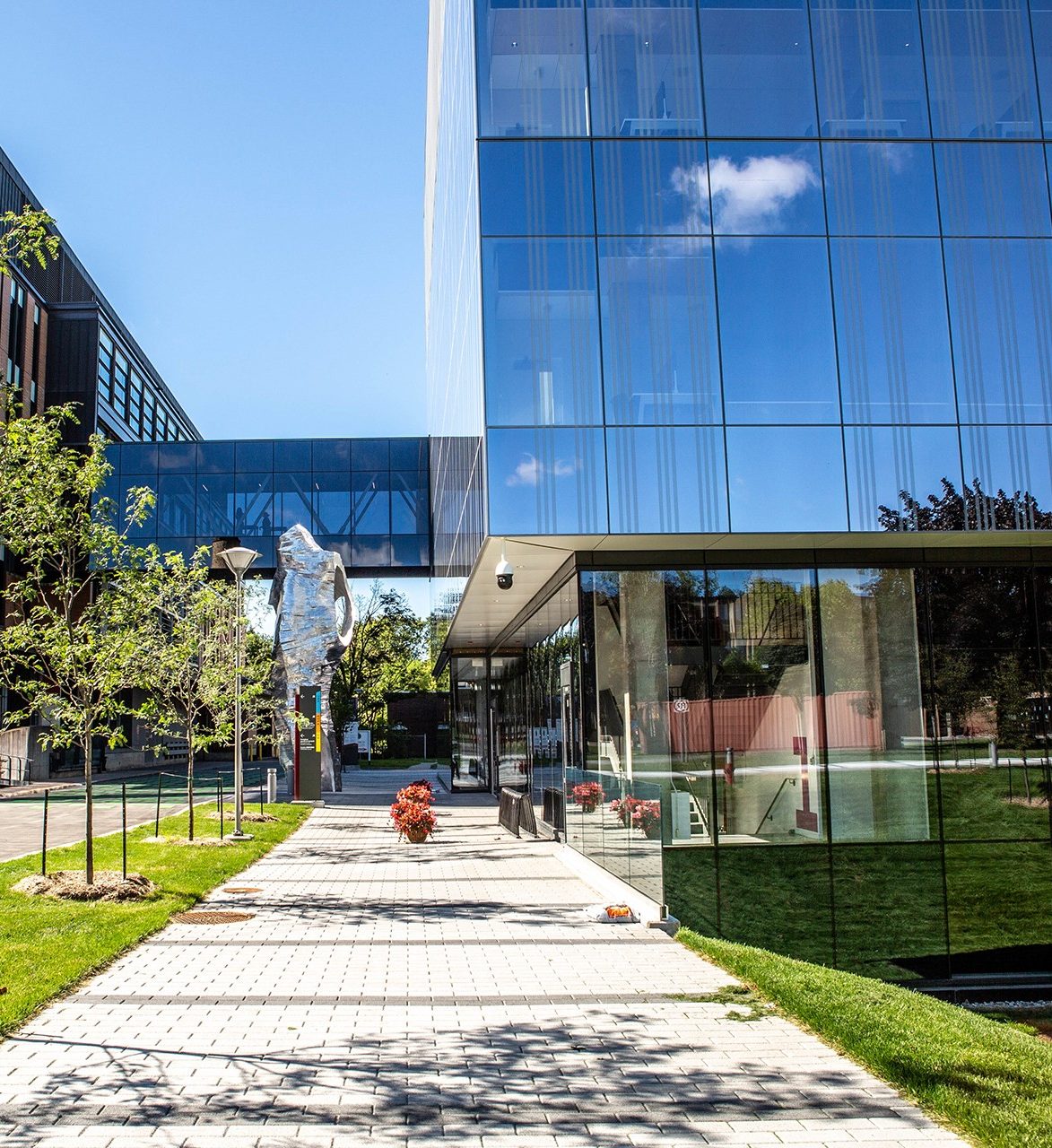 a sculpture along a path between buildings at the Applied Science Hub on Concordia University's Loyola Campus