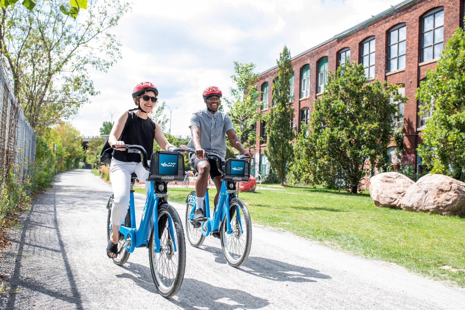 A blue BIXI bike against a yellow wall