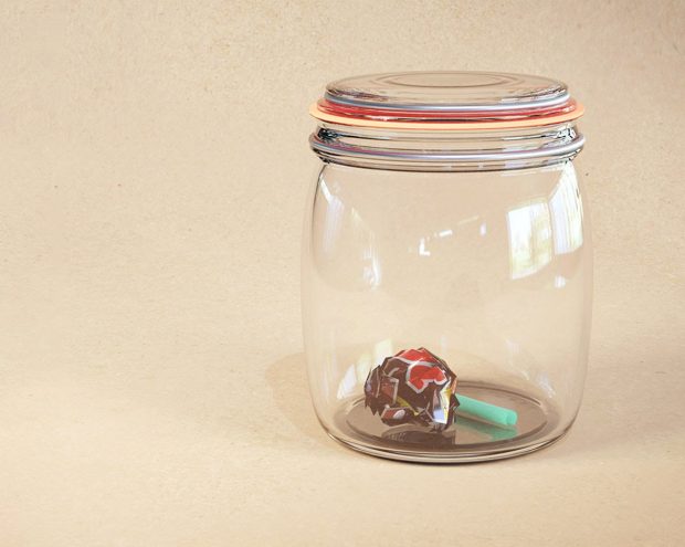 Glass jar with trash inside.