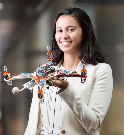 Screenshot of woman holding a drone, cropped to headshot 11:12