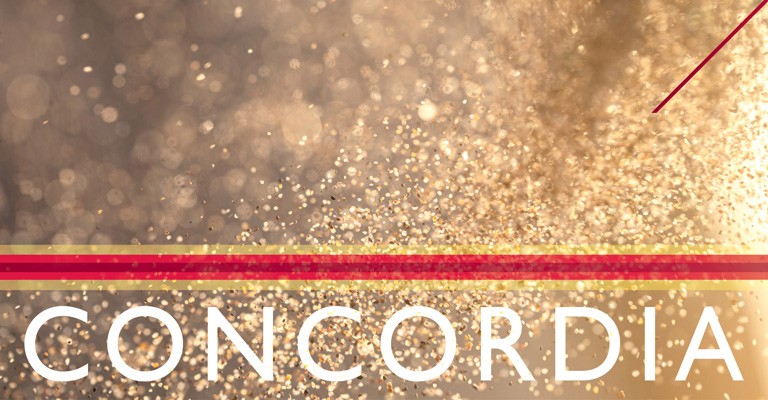 A close-up view of scattered golden glitter dust, reflecting light and creating a shimmering effect.