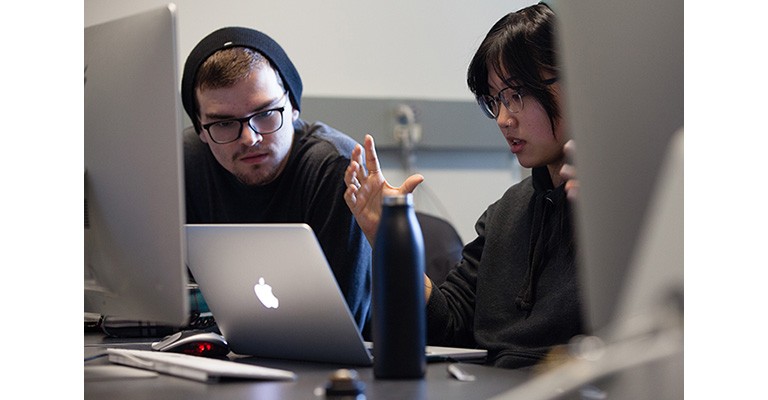 Two people working at a computer