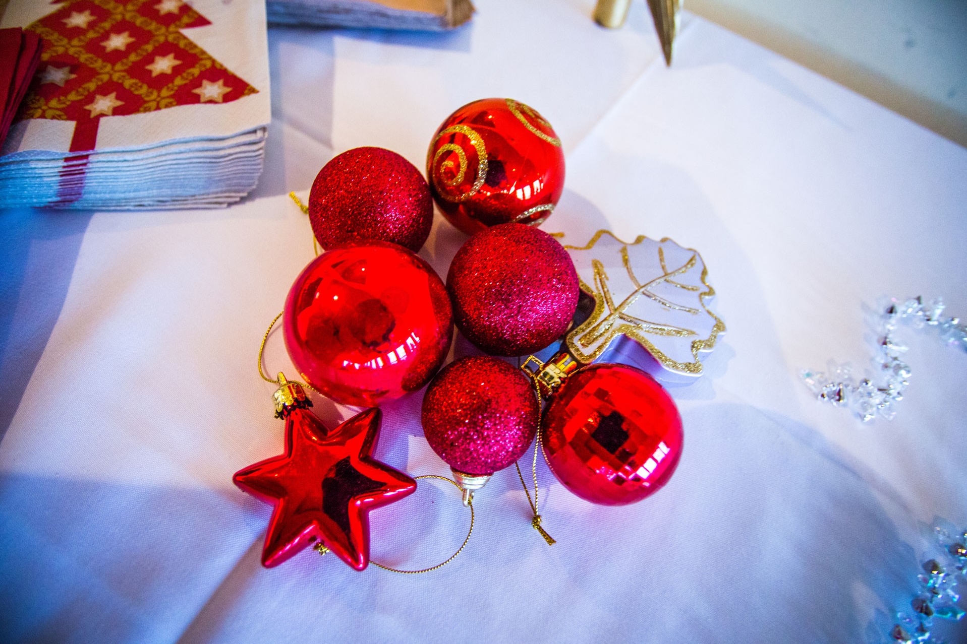 Colourful holiday ornaments on a white tablecloth