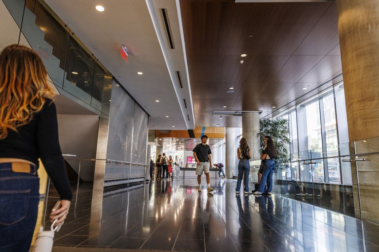Students conversing in the lobby of the John Molson Building