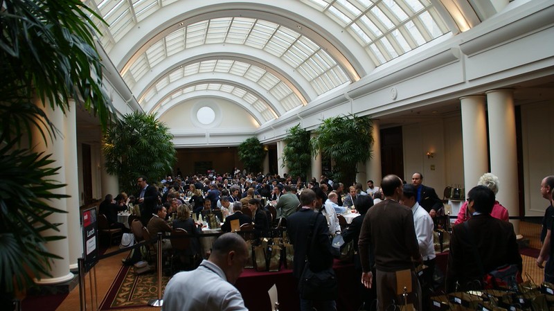 People gathered in a dommed building for a conference presentation