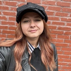 White woman with brown hair smiling, close up of just her head.