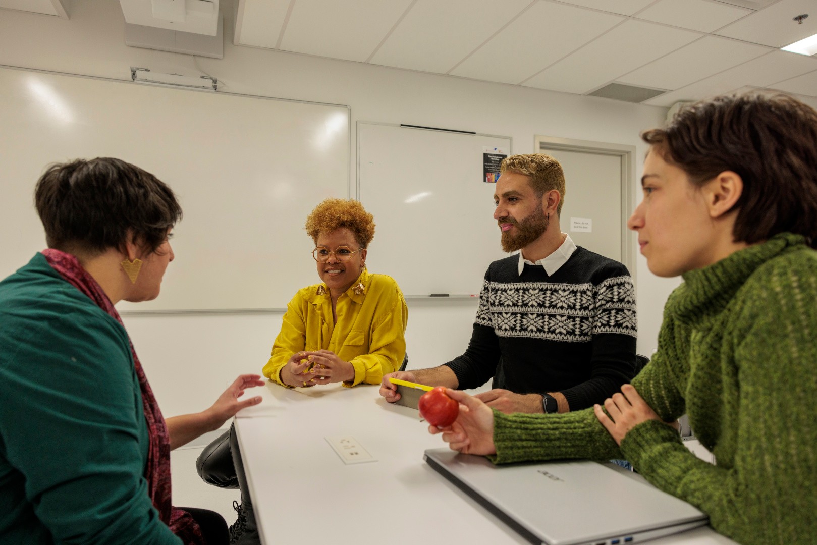 A leader speaks to her team members