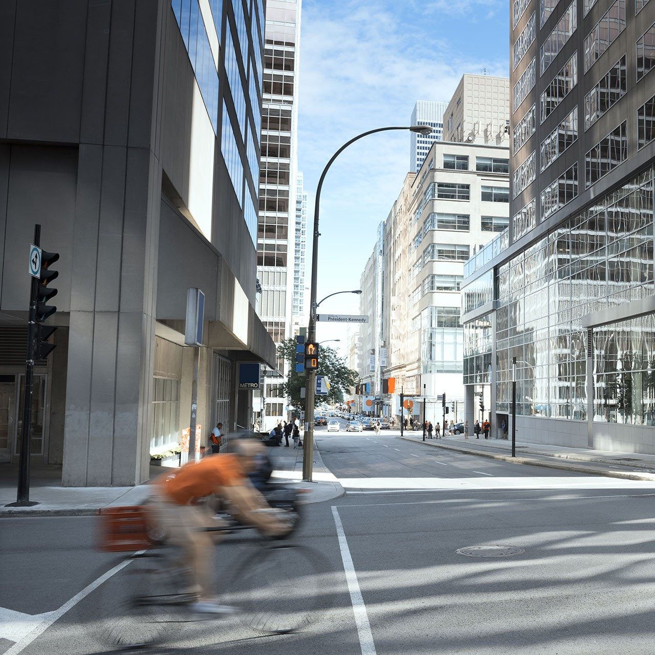 Person riding a bicycle in an urban environment.