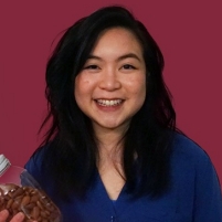 Dietitian Jessy Cheung holds a bottle of almonds and an orange