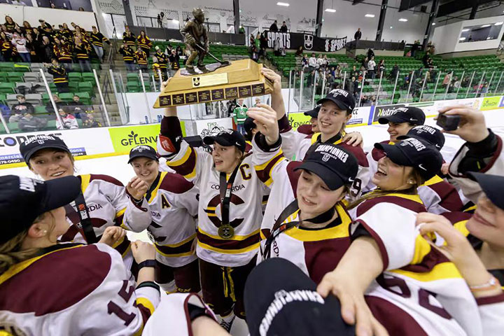 Concordia Stinger captain, Emmy Fecteau, holds Golden Path Throphy - photo by Electric Umbrella