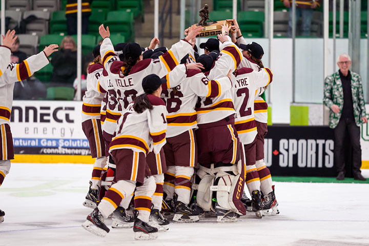 Concordia Stingers Women's Hockey Team celebrates with Golden Path Trophy