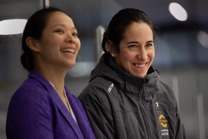 Caroline Ouellette on the bench with Stingers coach Julie Chu.