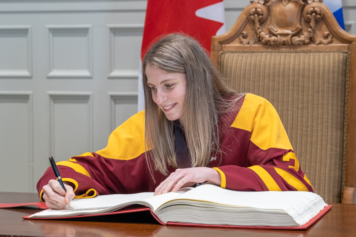 All-star goaltender Alice Philbert writes her name in the prestigious book