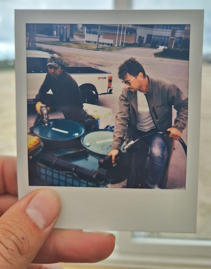 Gianni Gallaccio fills the fuel barrels in the back of a truck at a gas station in Mistissini, Quebec. 