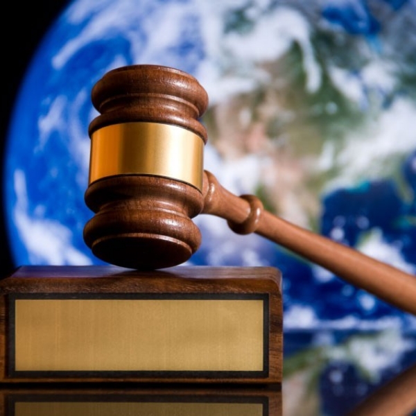 A gavel with Planet Earth in the background