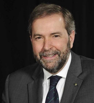 Headshot of smiling man wearing grey blazer, white shirt and striped navy tie
