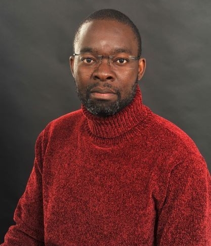 Portrait of man wearing glasses and red velour turtleneck