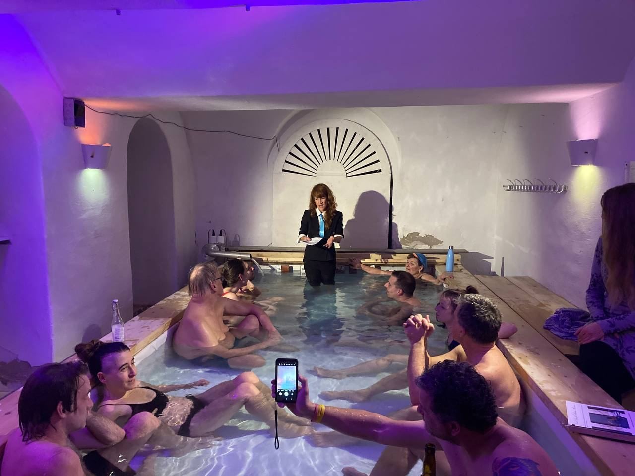 A woman giving a talk inside a pool