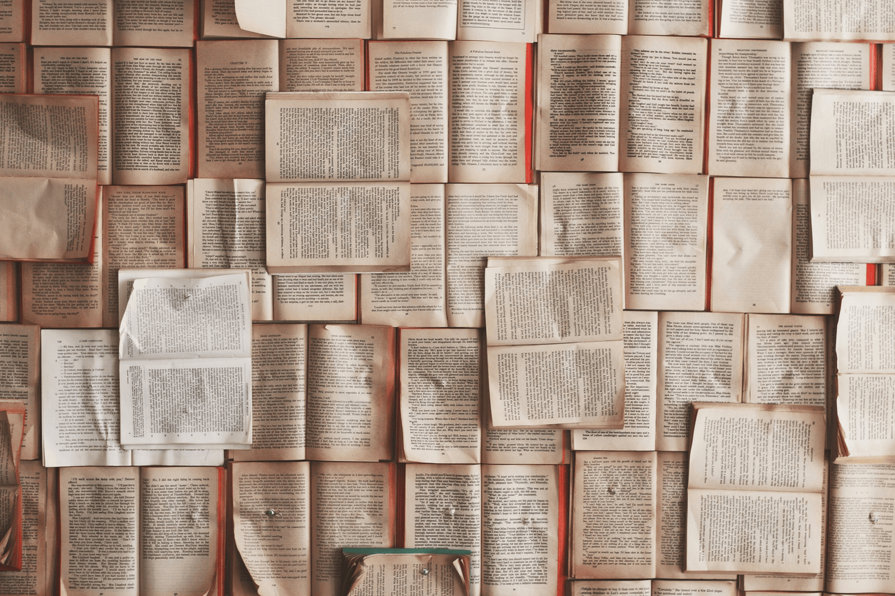 Open books on an orange background.
