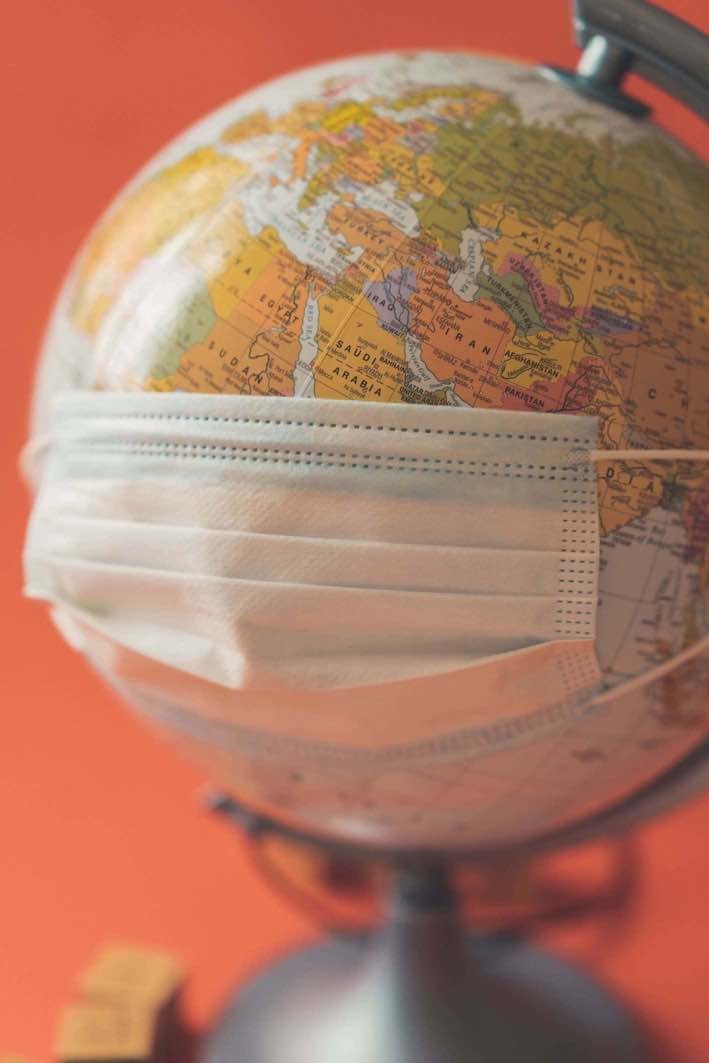Image of a globe wearing a medical face mask.