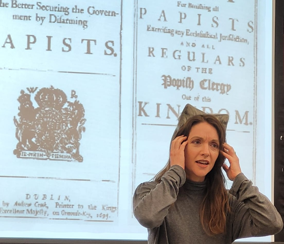 A woman dressed as a wolf, lecturing