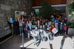 Picture of a group of students, faculty, and staff with climate protest signs