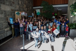 Picture of a group of students, faculty, and staff with climate protest signs