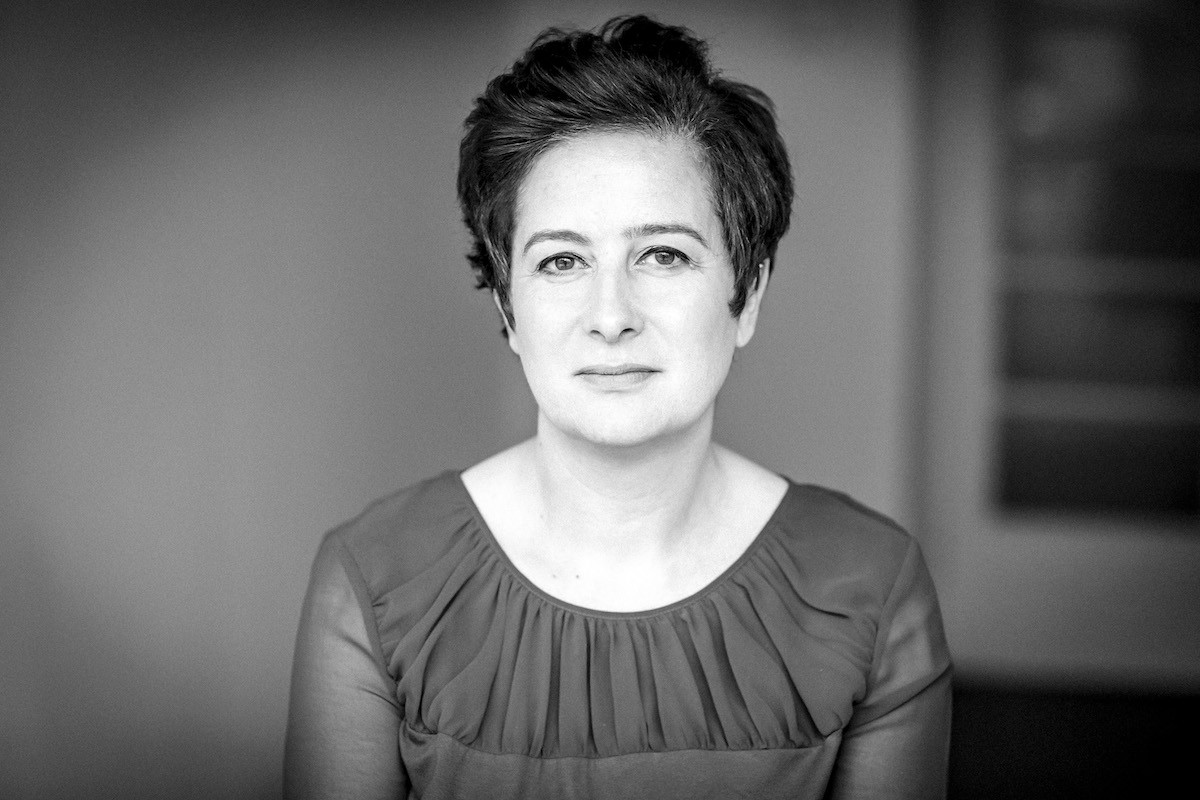 Black-and-white headshot of woman with short dark hair