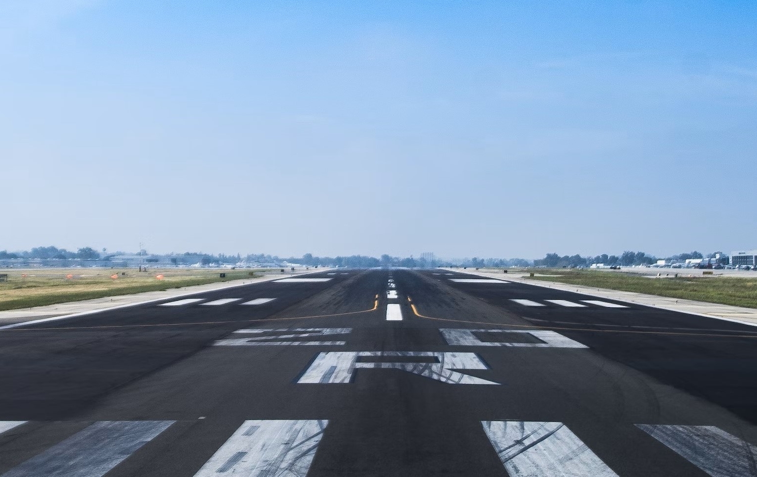 Image showing an empty runway under blue skies.
