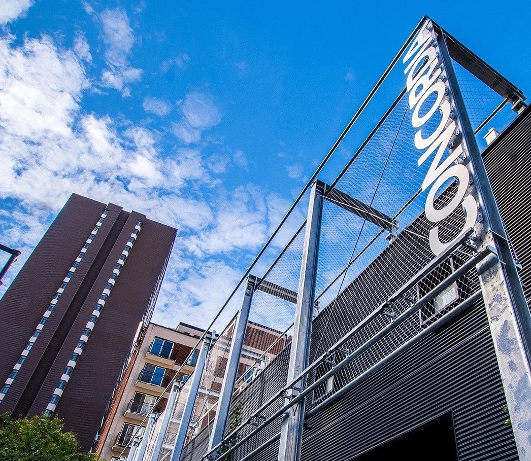 One storey black building with Concordia logo in metal letters on building