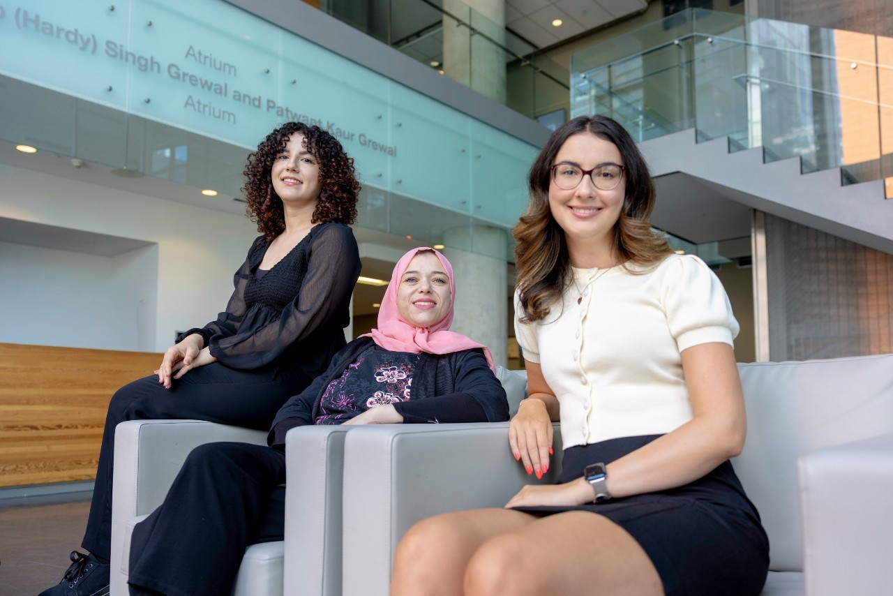 Three women seated in the MB building