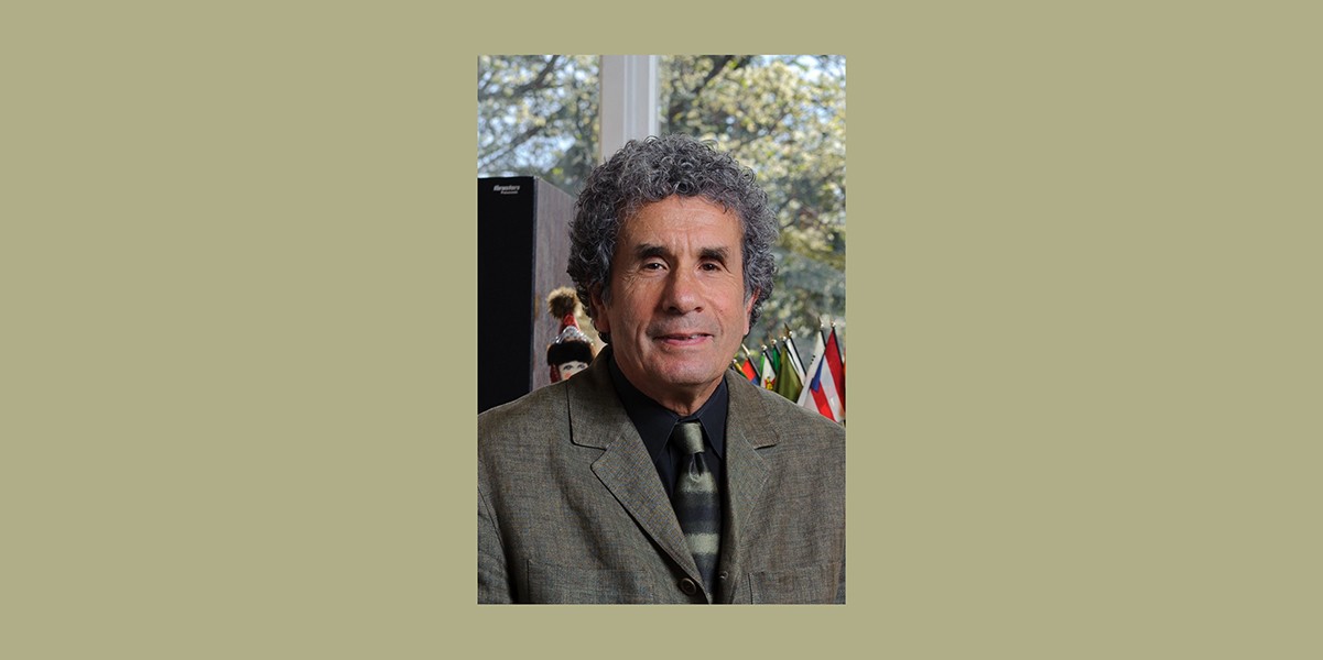 Portrait of man wearing grey blazer and black dress shirt and stripped tie