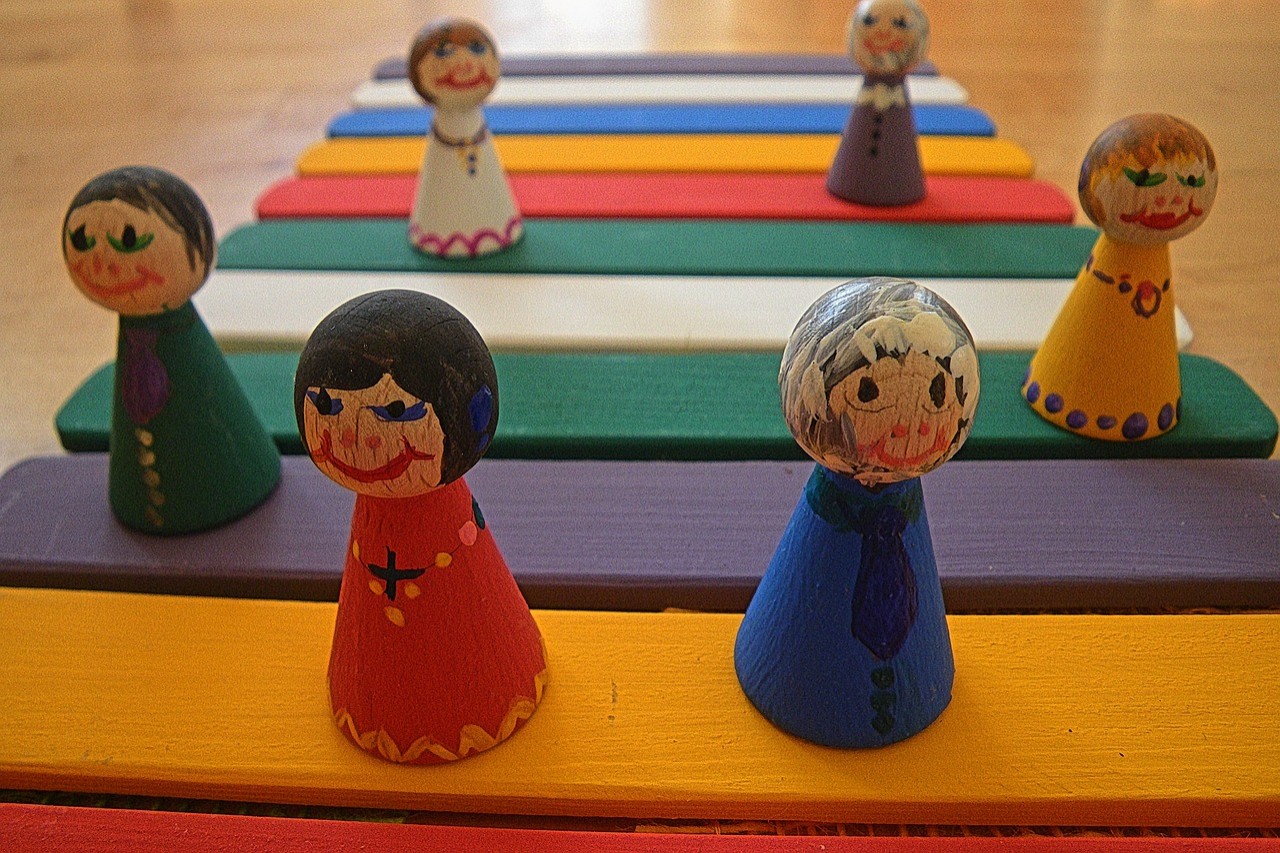 Small painted wooden figurines of older people.