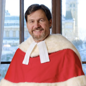 Smiling man with brown hair and beard