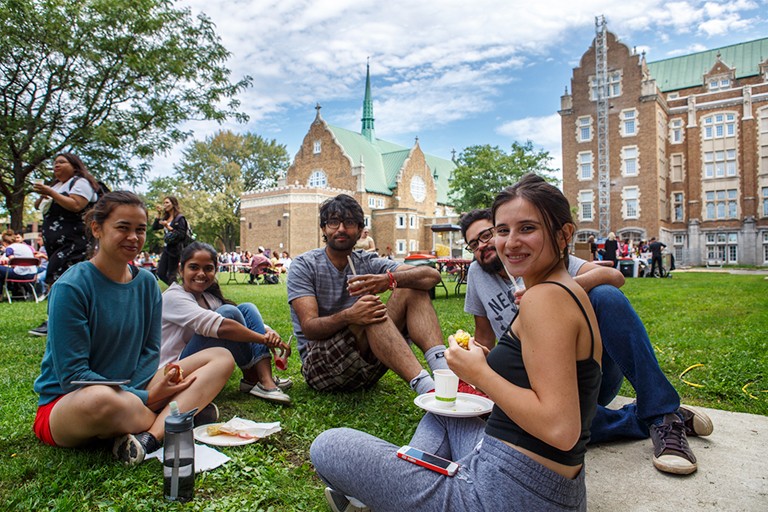 Students enjoy refreshments on green lawn on Loyola Campus
